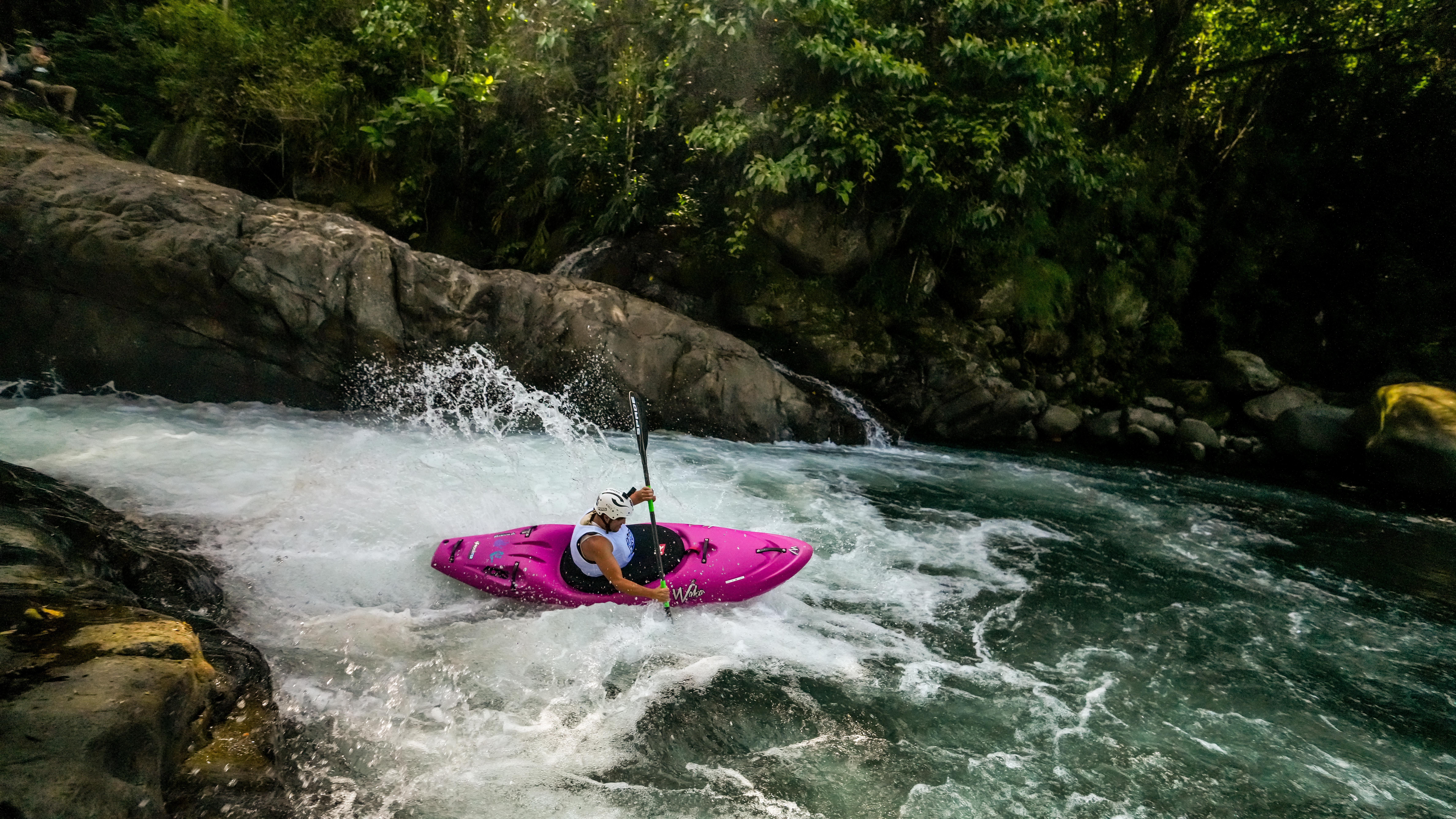 Kayaker dropping a rapid