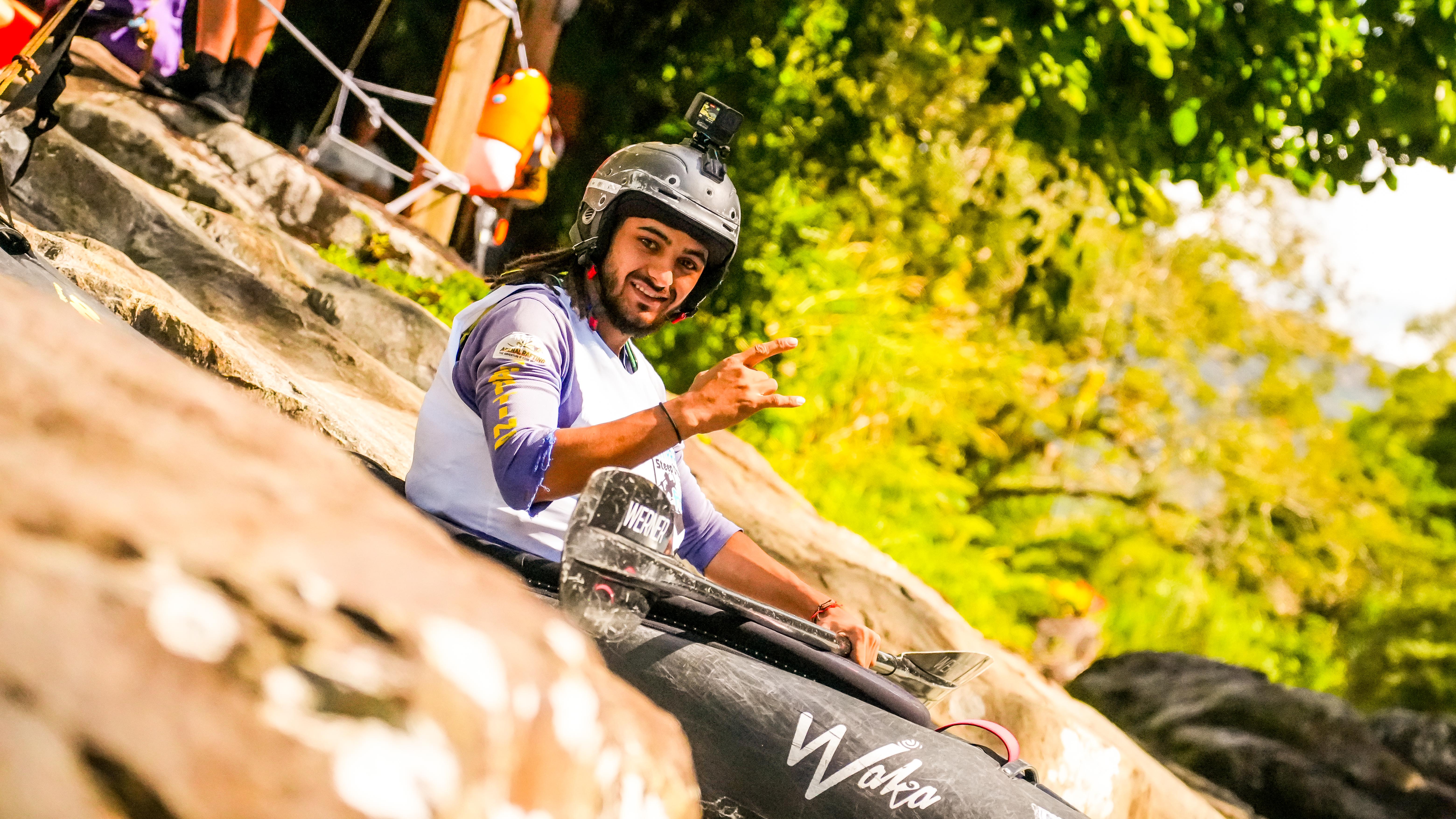 Paddler smiling mid-river