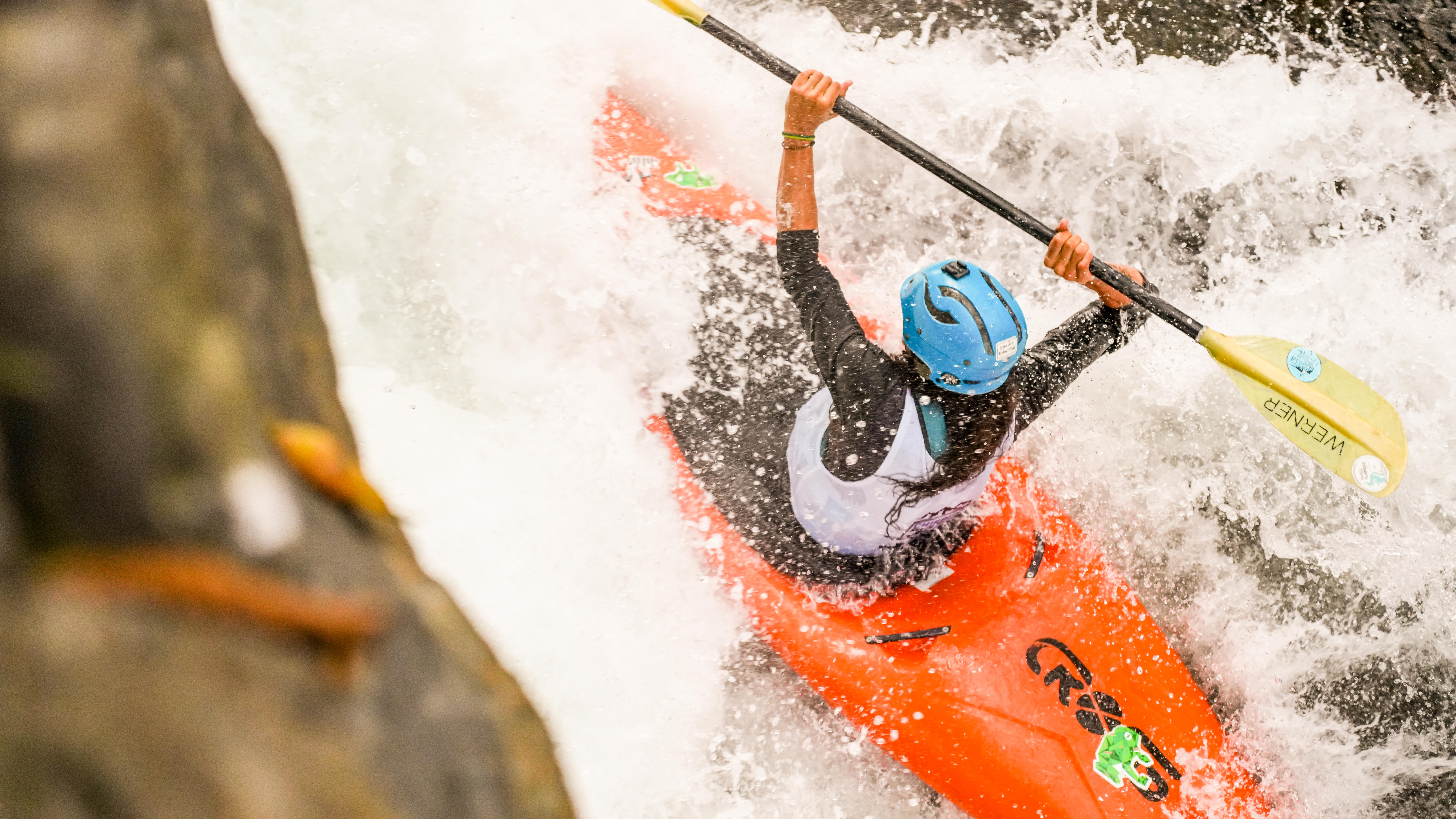 Paddler overhead in an orange boat